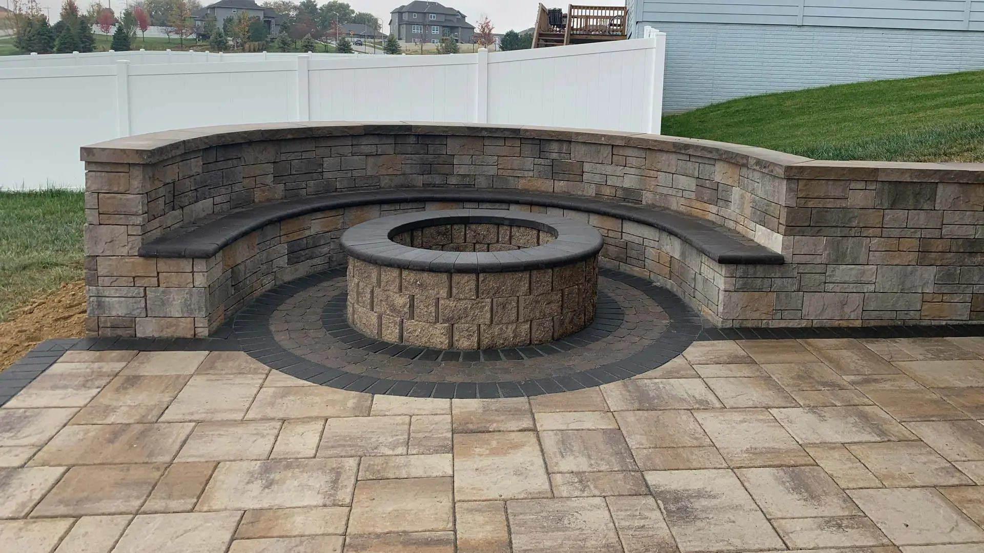 Stone seating wall instead beside a firepit in Lincoln, NE.