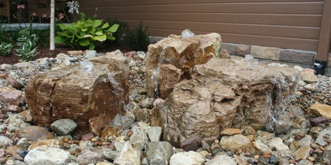 Custom water feature in landscaped yard